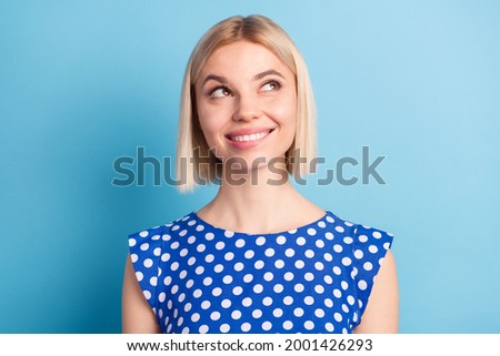 Photo portrait girl with blonde bob hair smiling looking empty space curious dreamy isolated pastel blue color background