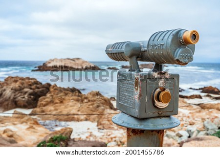 Tourist stationary observation binoculars for viewing rocks in the Pacific Ocean on the coast of California