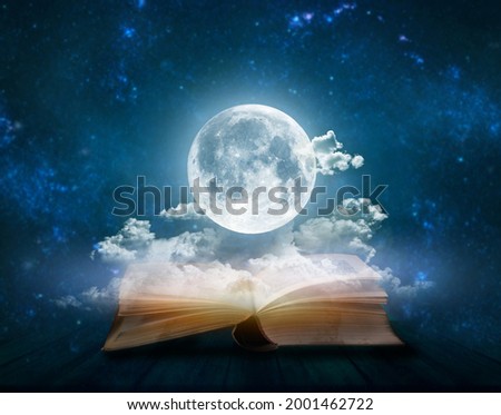 Full moon above open pages of old book; Astrology, zodiac, esoteric concept Royalty-Free Stock Photo #2001462722