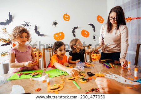 Happy children during Halloween art lesson at home