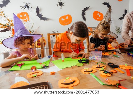 Happy children during Halloween art lesson at home Royalty-Free Stock Photo #2001477053