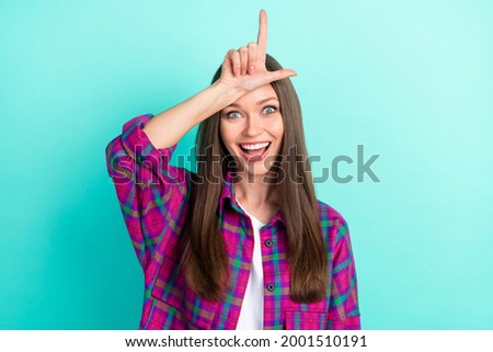 Portrait of attractive cheerful girl showing horn sign bullying isolated over bright teal green color background