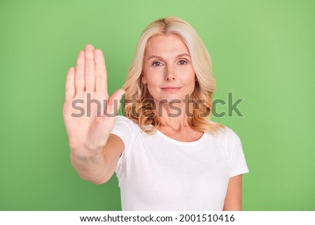 Photo portrait elder woman showing stop sign with hand isolated on pastel green color background