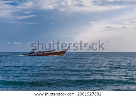 Traditional wooden long tail boat cruising on the sea, Amazing tropical nature view background