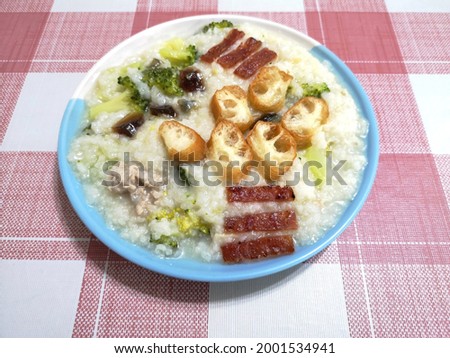 Traditional Asian porridge with variety of ingredients like broccoli, minced meat, sliced deep-fried dough sticks, preserved egg. Suitable for senior citizens.