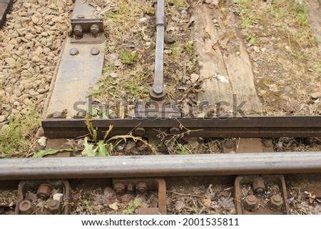 Mechanical turnout switch of railway tracks. The mechanism is modern, electric railroad switch. Close up arrows
