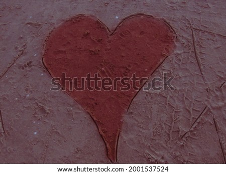 Beautiful heart symbol painted with sand at the beach.