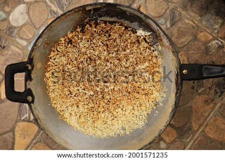 The rices in iron pan is burnt from fire stove, it over time on cooking ,it loss at all