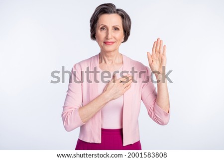 Photo of aged woman happy positive smile hold hand swear promise make oath promise tell truth isolated over grey color background