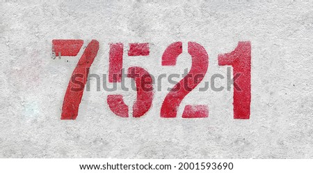 Red Number 7521 on the white wall. Spray paint. Number seven thousand five hundred and twenty one.