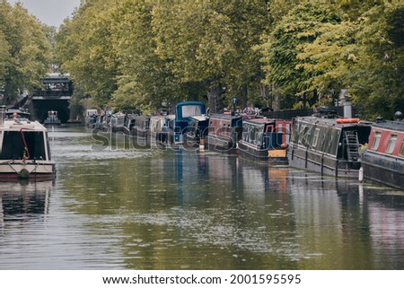 Rows of houseboats and narrow boats on the Regent's canal on Maida Avenue, Little Venice, West London. Royalty-Free Stock Photo #2001595595