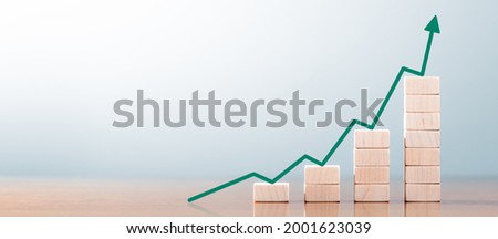 Wooden Block Statistics Graph With Arrow Showing Exponential Growth Trend Royalty-Free Stock Photo #2001623039
