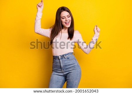 Photo of optimistic brunette lady dance wear pink shirt isolated on yellow color background
