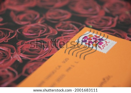 US Love themed stamp close up on orange envelope