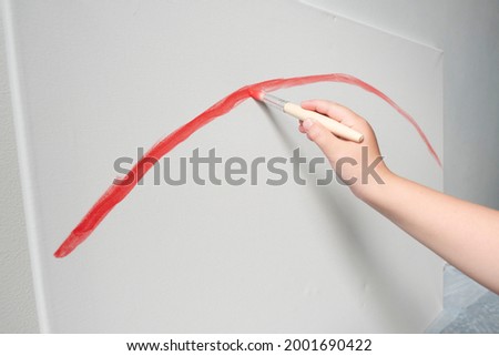 kid drawing red line art with paints rainbow