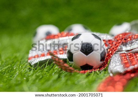 Soccer ball with Christmas Holiday Decoration on green grass