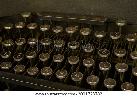 A closeup view of an old typewriter keypad designed for the English language typescript.