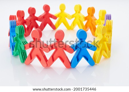 Rainbow, colourfull people concept. High resolution photo for graphic design. Different race, different skin colour concept, plastic people statuettes holdings hands.