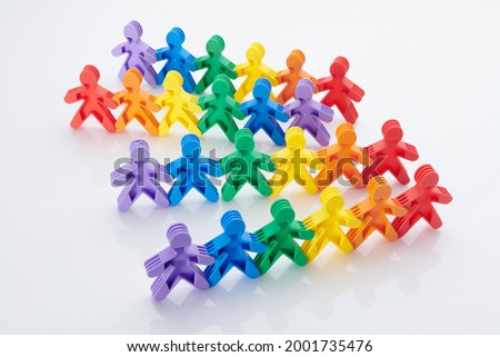 Rainbow, colourfull people concept. High resolution photo for graphic design. Diffrent race, diffrent skin colour concept, plastic people statuettes holdings hands.