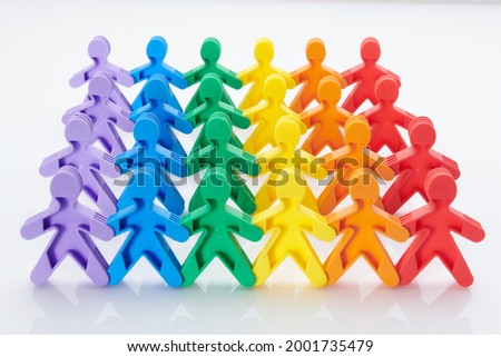 Rainbow, colourfull people concept. High resolution photo for graphic design. Diffrent race, diffrent skin colour concept, plastic people statuettes holdings hands.