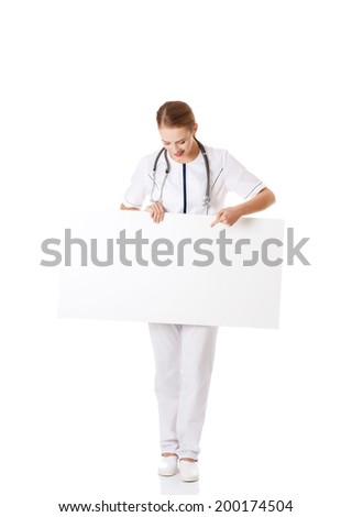 Beautiful caucasian nurse or doctor holding empty white board. Isolated on white.