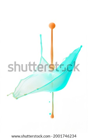 Orange water drops collide with a light green forming a cup shape on a white background - Liquid Drop Art