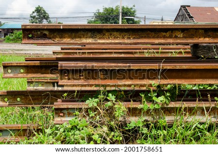 Old train tracks for transport have rust waiting for maintenance.