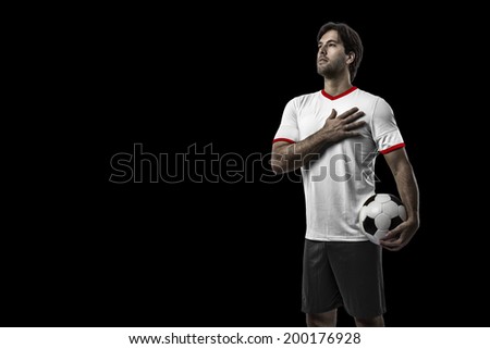 American soccer player, celebrating on a black background.