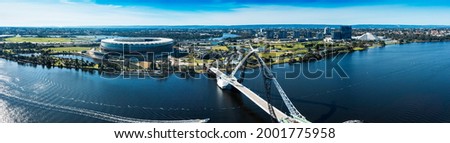 East Perth, Western Australia. Aerial panorama showing Matagarup Bridge pedestrian suspension bridge crossing the Swan River in Perth, and also Perth Stadium. Royalty-Free Stock Photo #2001775958