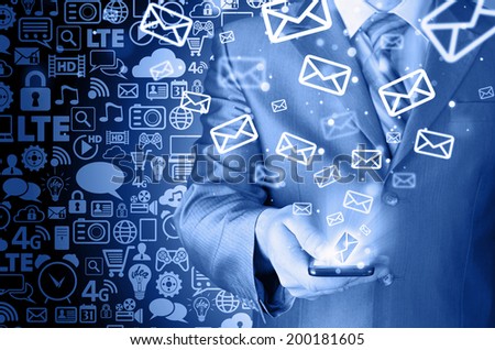 Business man holding smart phone and sending emails