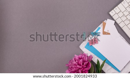 Workplace with Keyboard Peony White Blank and Paper Clips on Gray Background Top View Flat Lay Banner FreeLance Concept advertising