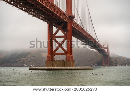 Golden Gate Bridge in fog. View from the Fort Point embankment.	