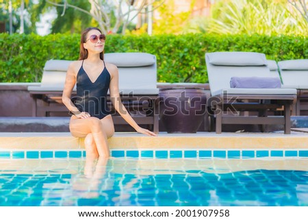 Portrait beautiful young asian woman relax smile leisure around outdoor swimming pool nearly sea beach ocean for holiday vacation