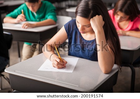 Group of high school students taking a test in a classroom