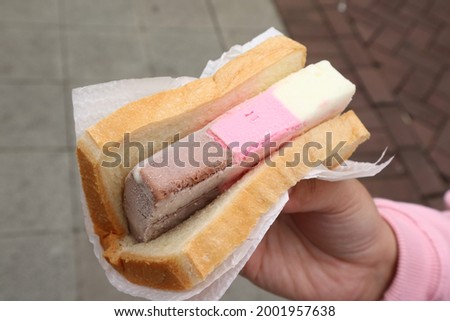 Hand Holding Ice Cream Sandwich, commonly called Singapore ice cream Royalty-Free Stock Photo #2001957638