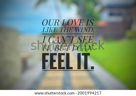 Inspirational love quote "OUR LOVE IS LIKE THE WIND" isolated on a blurry background.