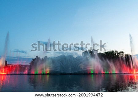 Musical fountain with laser animations. Night laser fountain show, on the Roshen embankment, the Ukrainian city of Vinnitsa.
