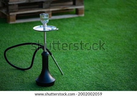 Hookah stands on a green lawn on vacation 