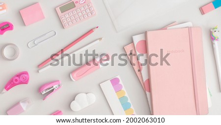 Pattern composition of school stationery on a grey background. Top view with copy space. Flat lay. Back to school concept.