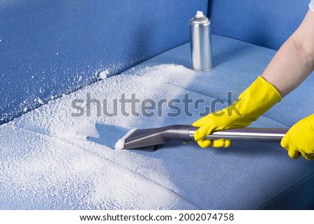cleaning upholstered furniture upholstery with chemicals and a vacuum cleaner Royalty-Free Stock Photo #2002074758