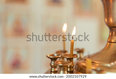 2 candles in an Orthodox church on a light background