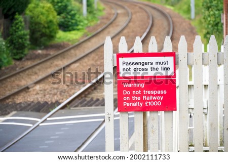 Stop look listen safety road sign at railway train station danger warning sign
