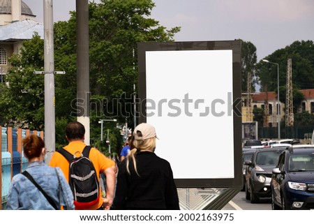 selective focus. Billboard on asphalt road. billboard near people walking