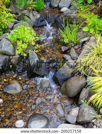 Bubbling brook water feature with stones and plants