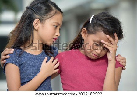 Asian Girl Has Compassion For Sad Friend Royalty-Free Stock Photo #2002189592