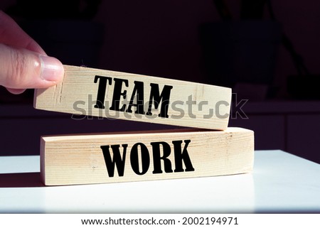 Team Work - text on wooden cubes on a gradient background. HUMAN RESOURCES the ability of a group of people to work well together