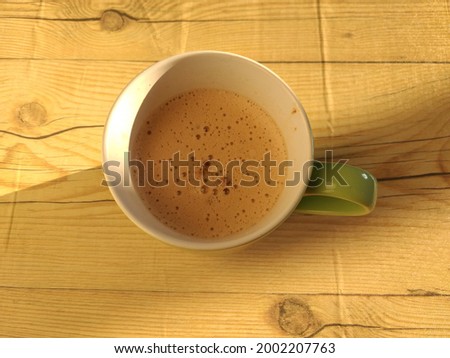 a photo of a cup of coffee placed on the table