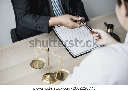 Attorney gives the client a pen to sign a contract admitting fraud, lawyer admits a fraud case in which client is a victim and will sue defendant who is a commercial partner. Fraud litigation concept. Royalty-Free Stock Photo #2002220975