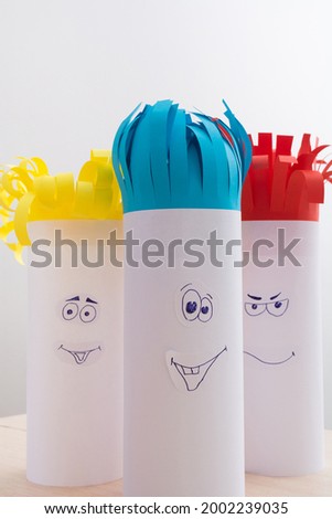 Creativity paper handmade for children. Funny faces on tubes with colorful hair