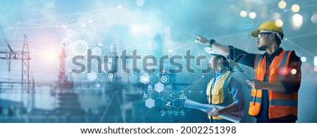 Male and female industrial engineers using tablet computer and blueprints checking and analysis data of power plant station project on network background. Royalty-Free Stock Photo #2002251398